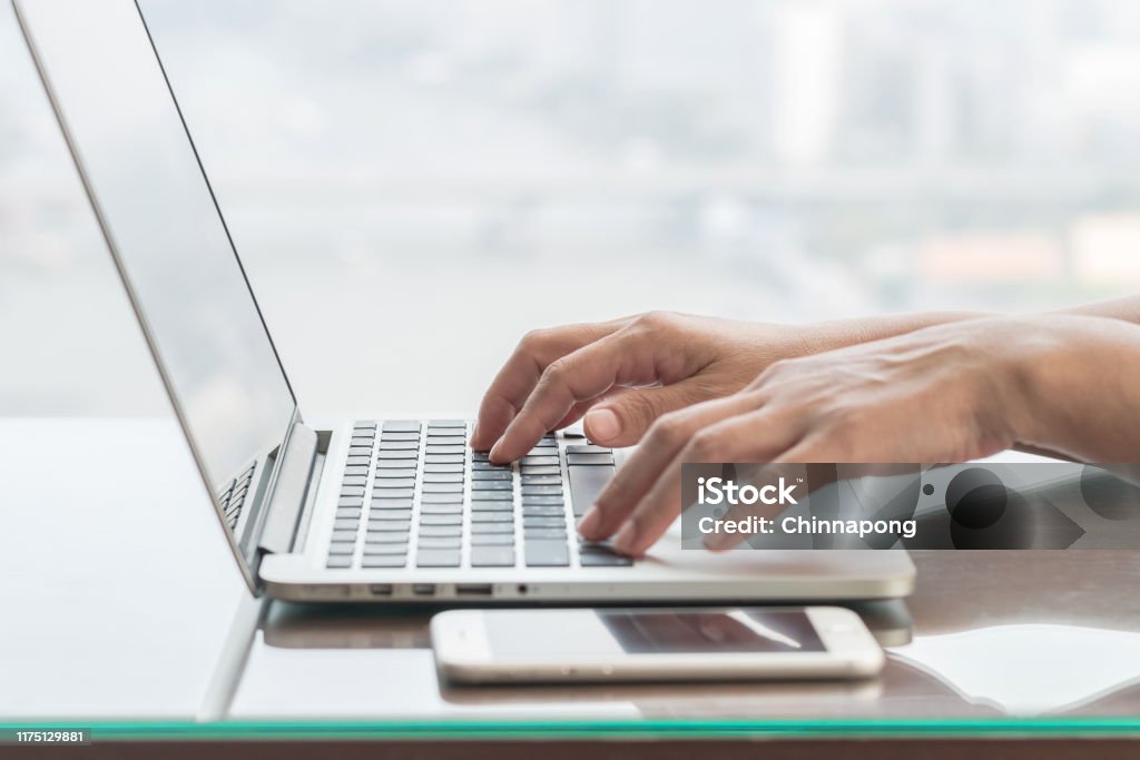 someone typing on a laptop